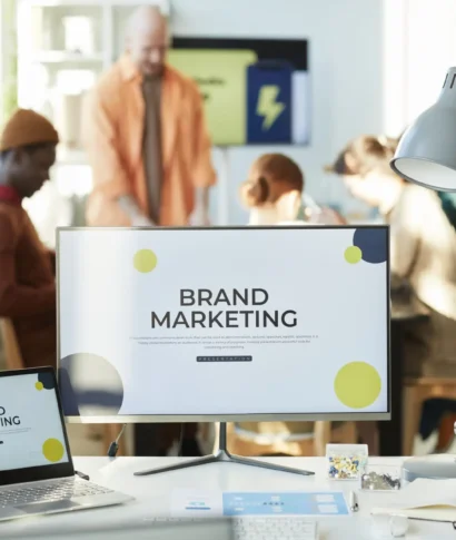 Background image of computer screen with Brand marketing slogan on desk in office